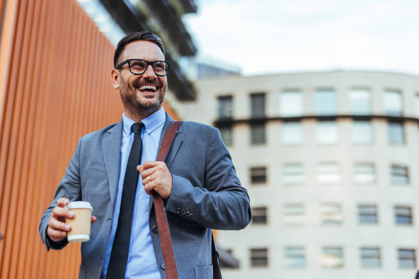 istock Confident Businessman Walking with Coffee in Urban Environment 2185403563