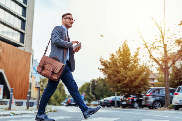 istock Confident Businessman Crossing Street with Briefcase 2185403573