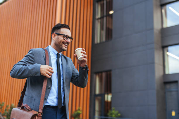 istock Businessman Walking Outside Holding Coffee and Briefcase 2185403588