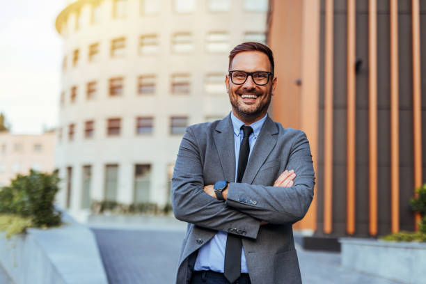 istock Confident Businessman Smiling Outdoors in Urban Setting 2185403595