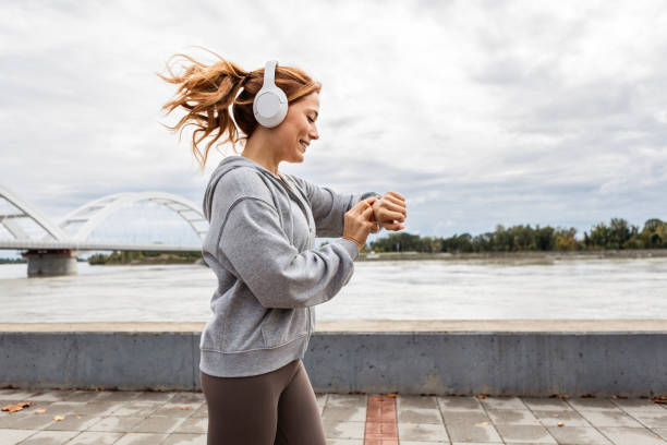 istock Jogging by the River  Looking At Smart Watch 2185403888