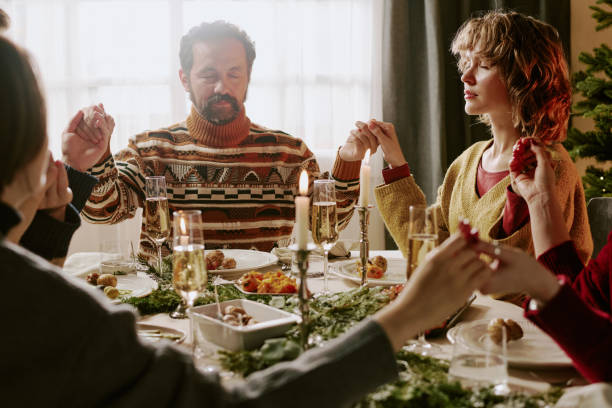 istock Family Saying Prayer at Table 2185404150
