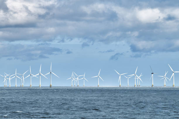 istock Wind turbine farm in the sea. 2185404257