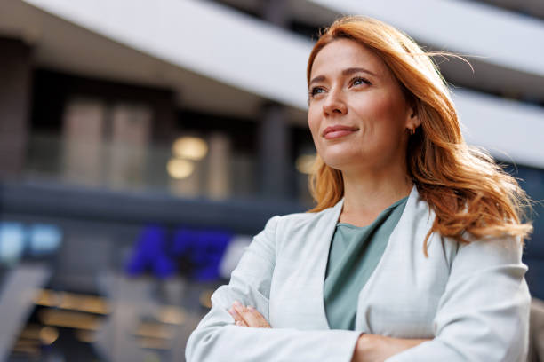 istock Confident woman with folded arms outside office building. 2185404531