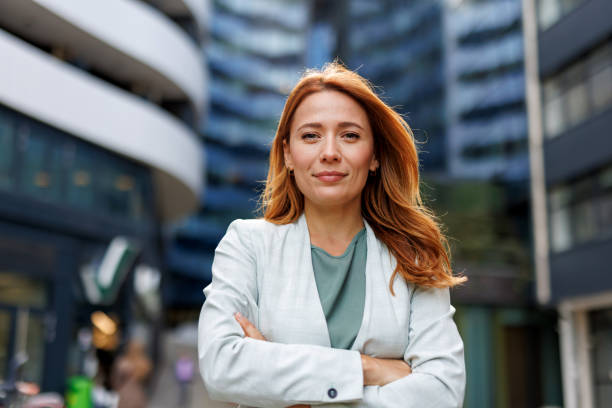 istock Businesswoman standing confidently amidst urban architecture. 2185404539