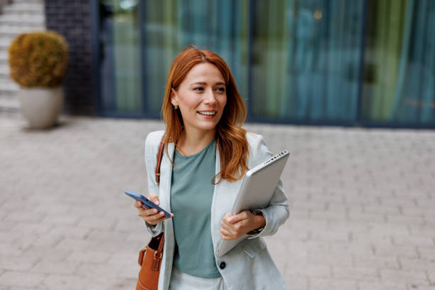 istock Professional woman balancing technology and ambition outdoors 2185404693