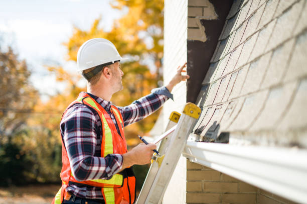 istock man with hard hat standing on steps inspecting house roof 2185404695