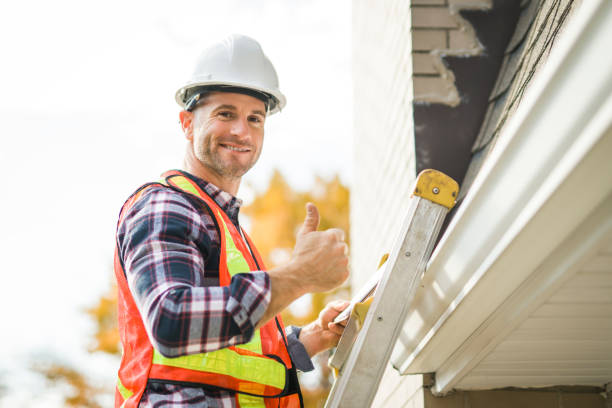 istock man with hard hat standing on steps inspecting house roof 2185404702