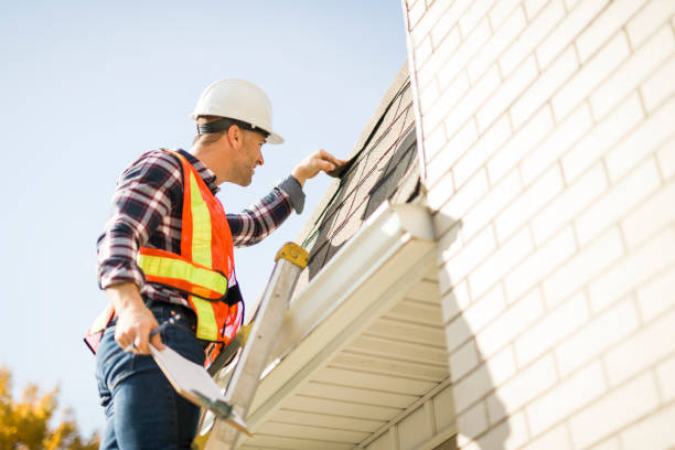 istock man with hard hat standing on steps inspecting house roof 2185404731