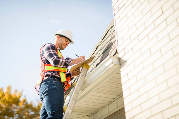 istock man with hard hat standing on steps inspecting house roof 2185404739