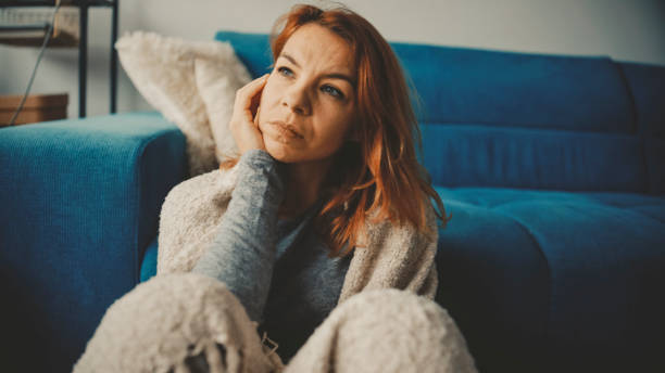 istock Distressed Mid Adult Woman Reflecting in Home Setting 2185406992