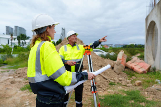 istock Male and female construction engineers discuss and use machines and macros for large construction projects. 2185408716