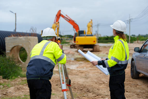 istock Male and female construction engineers discuss and use machines and macros for large construction projects. 2185408748