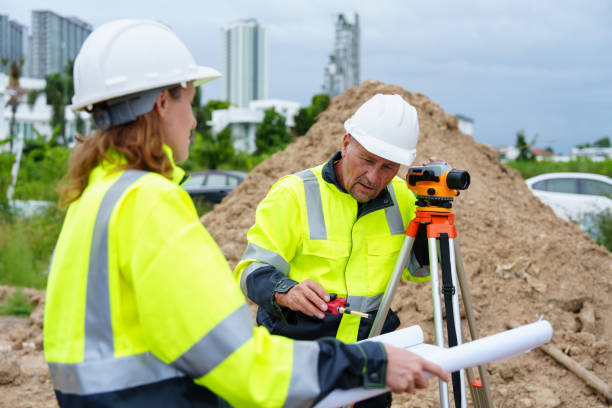 istock Male and female construction engineers discuss and use machines and macros for large construction projects. 2185408752