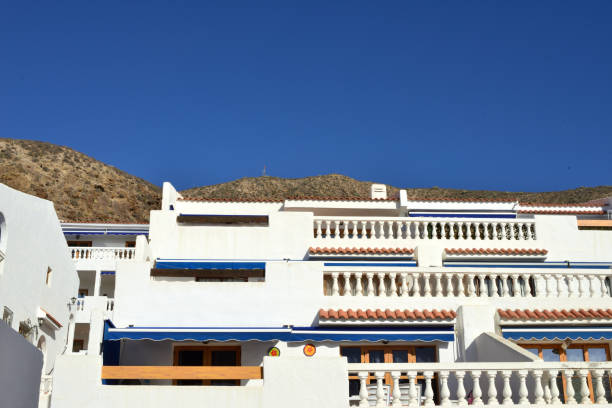 Arona Santa Cruz de Tenerife, Canary Islands, Spain - October 19, 2024: holiday hotel apartment terraced houses in terraced shape against the mountainside
