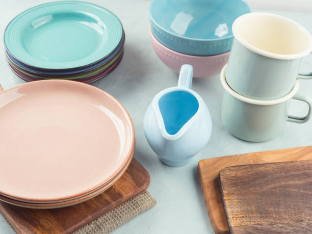 istock Set of pastel pink, blue color tableware on turquoise background 2185408914