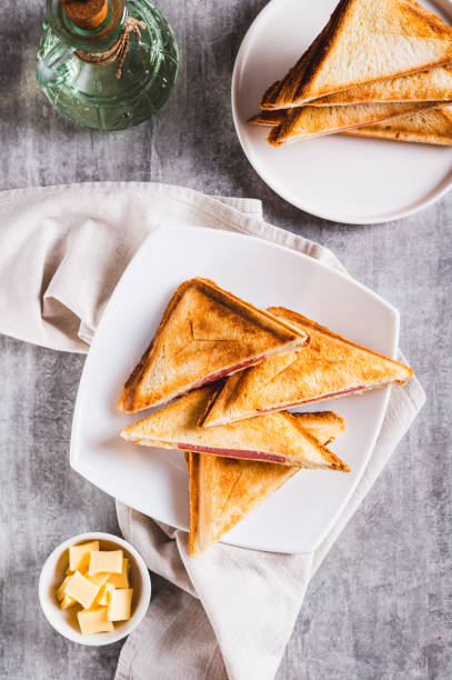 istock Toasted ham and cheese toasts on a plate on the table top and  vertical view 2185410240