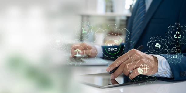 istock Business professional using tablet with eco-friendly and net zero icons, representing digital innovation in environmental sustainability and corporate responsibility for a low-carbon future 2185410733