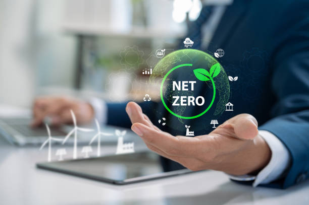 istock Corporate Sustainability and Net Zero Vision. Business Professional Holding Digital Icon Representing Renewable Energy, Carbon Neutrality, and Environmental Impact Goals 2185410756