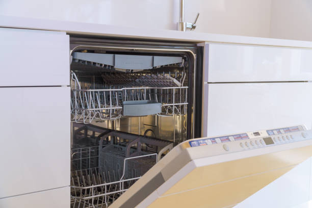 istock Modern kitchen with an open dishwasher showcasing clean dishes utensils in stylish home design 2185412081