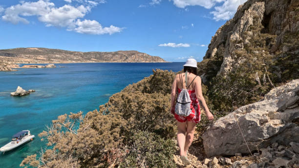 istock Woman walks along pathway above sea 2185412209