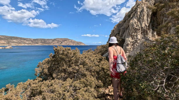 istock Woman walks along pathway above sea 2185412215