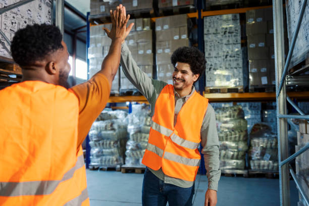 istock Interracial storage foreman giving high five and encouraging his new employee. 2185412394