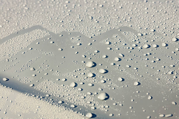 Raindrops on gray metal surface. Background and close-up.