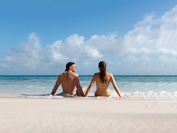istock Handsome man cute woman and white sand beach 2185413625