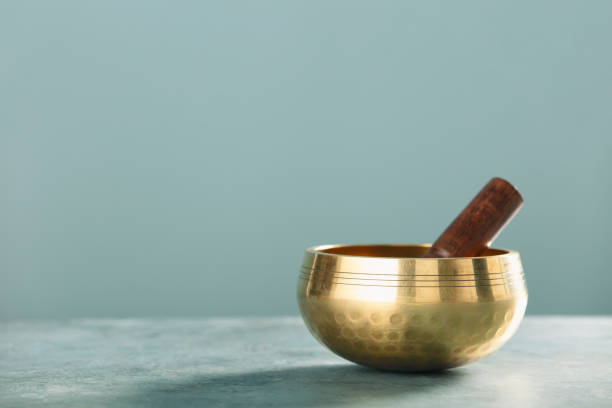 Golden Singing Bowl with Wooden Mallet for Meditation stock photo