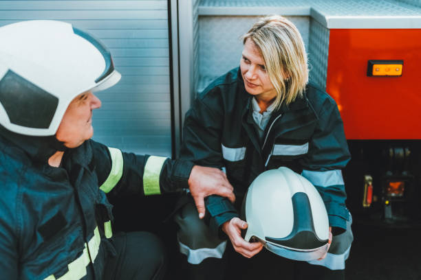 istock Firefighter consoling colleague after a hard day 2185416756