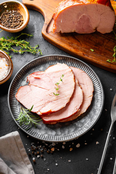 istock Sliced cold pork meat top view, boiled pork on black background 2185416826
