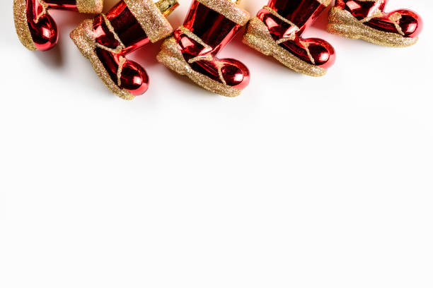 Christmas background with red Santa Claus felt boots on white background.