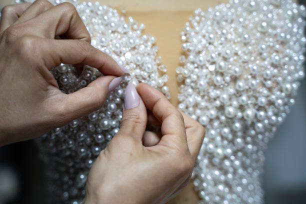 istock With pearl wedding dress is sewing 2185417556