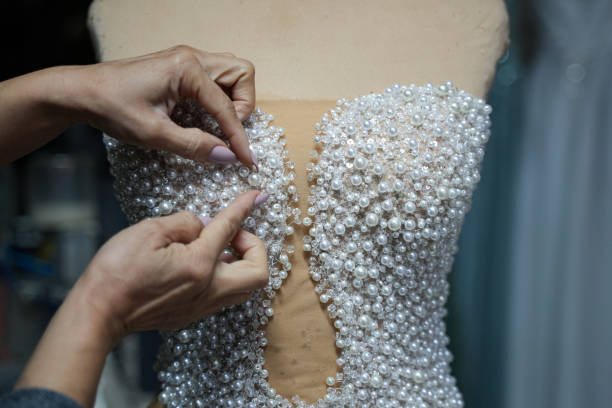 istock With pearl wedding dress is sewing 2185417561