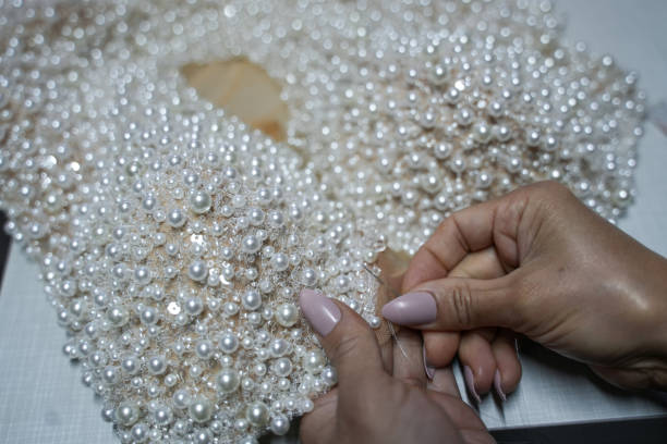 istock With pearl wedding dress is sewing 2185417564