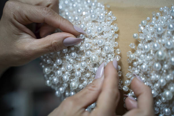 istock With pearl wedding dress is sewing 2185417569
