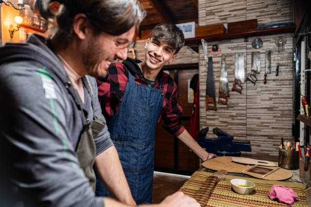 istock Father and son repairing guitar at home 2185417853