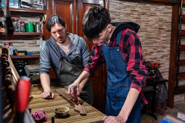 Father and son repairing guitar at home