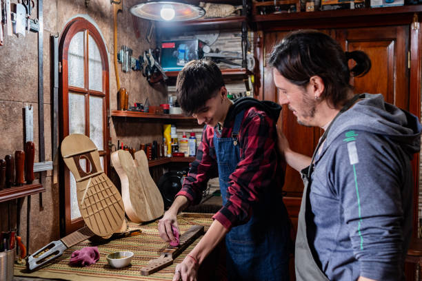 istock Father and son repairing guitar at home 2185417864