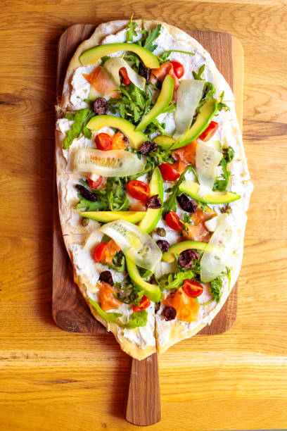 istock Flatbread style pizza served on wooden board 2185418238