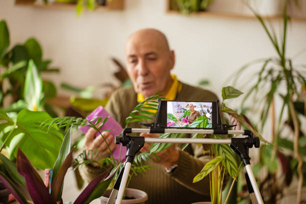 istock Elderly Man with Houseplants on Camera 2185418694