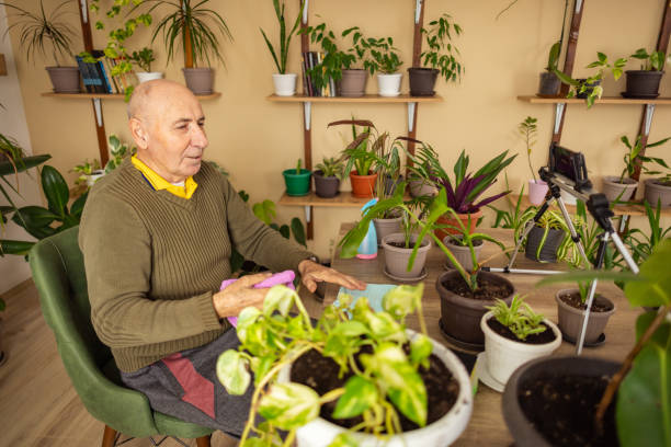 istock Older Man Showing How to Care for Plants 2185418799