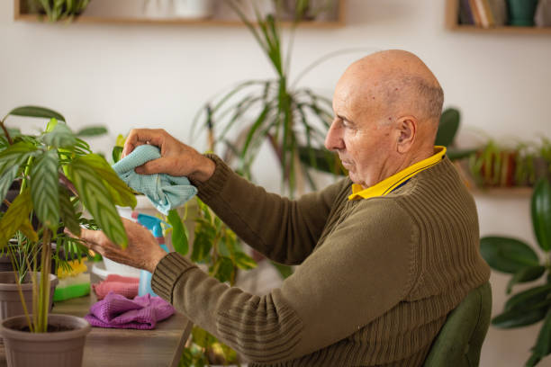 istock Man Spraying Water on Plants 2185419551