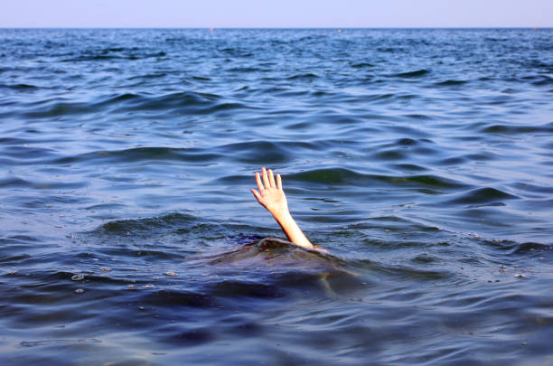 istock outstretched hand reaching above ocean waves symbolizing  depression 2185420126