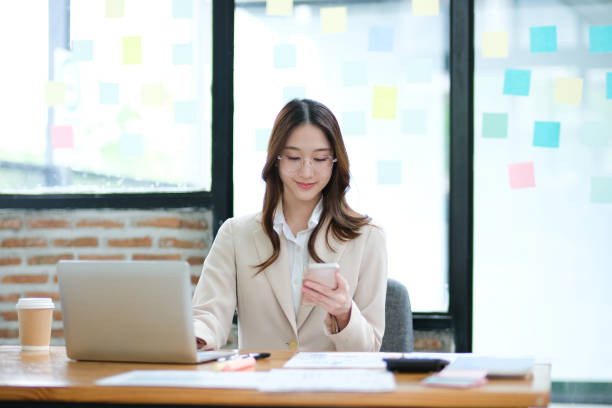 istock Businesswoman using a smartphone for communication, scheduling, and online business tasks. 2185420277