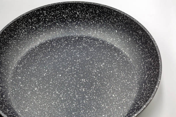 istock New frying pan closeup on white. 2185420988