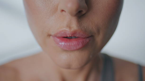 istock Girl doing breathing exercises at studio closeup. Macro open mouth making inhale 2185421583