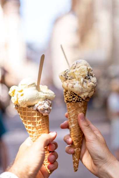istock Hands holding two creamy ice cream cones 2185423105