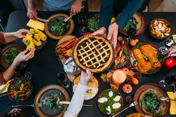 istock Happy family celebrating Thanksgiving at dining table. 2185423109